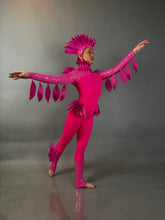 A dancer showcases the Pink bird full costume for aerial and dancers, featuring a bright pink design with a feathered headpiece and wing-like sleeves, perfect for theatrical performances.