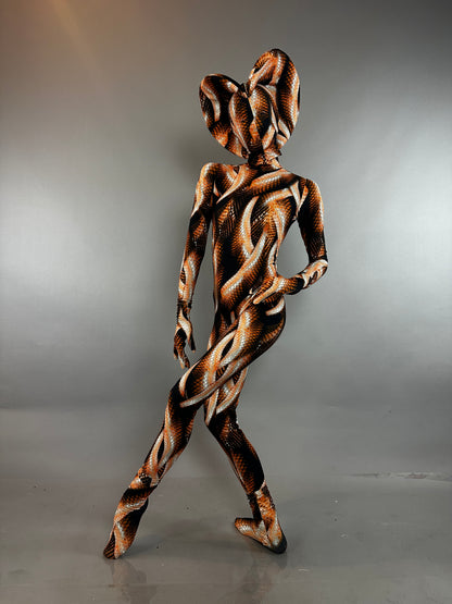 Person wearing a Brown Snake Print Turtleneck Catsuit with Back Zipper and matching headpiece in orange and brown.