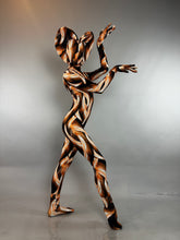 A person wearing a Brown Snake Print Turtleneck Catsuit with Back Zipper in a brown and black pattern.