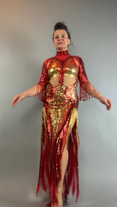 Person wearing the bearded French accessories Sequin Sheer Dress, which is backless with beaded fringe accessories, standing against a gray background.