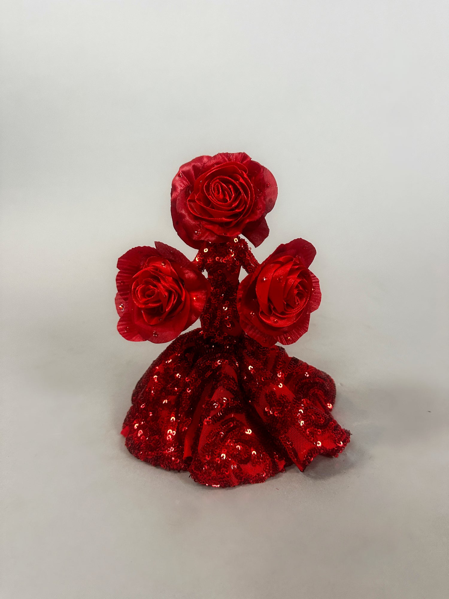 A magical art object by Kikimora Studio: the Mini Living Rose sculpture doll ornament, featuring three handcrafted red rose figures atop a sequined red dress.