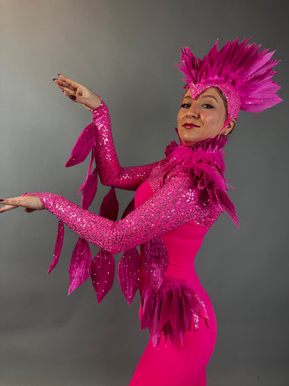A person wears the Pink bird full costume for aerial and dancers—vividly feathered and sequined—posing against a plain gray background, ideal for stage performances or theatrical shows.