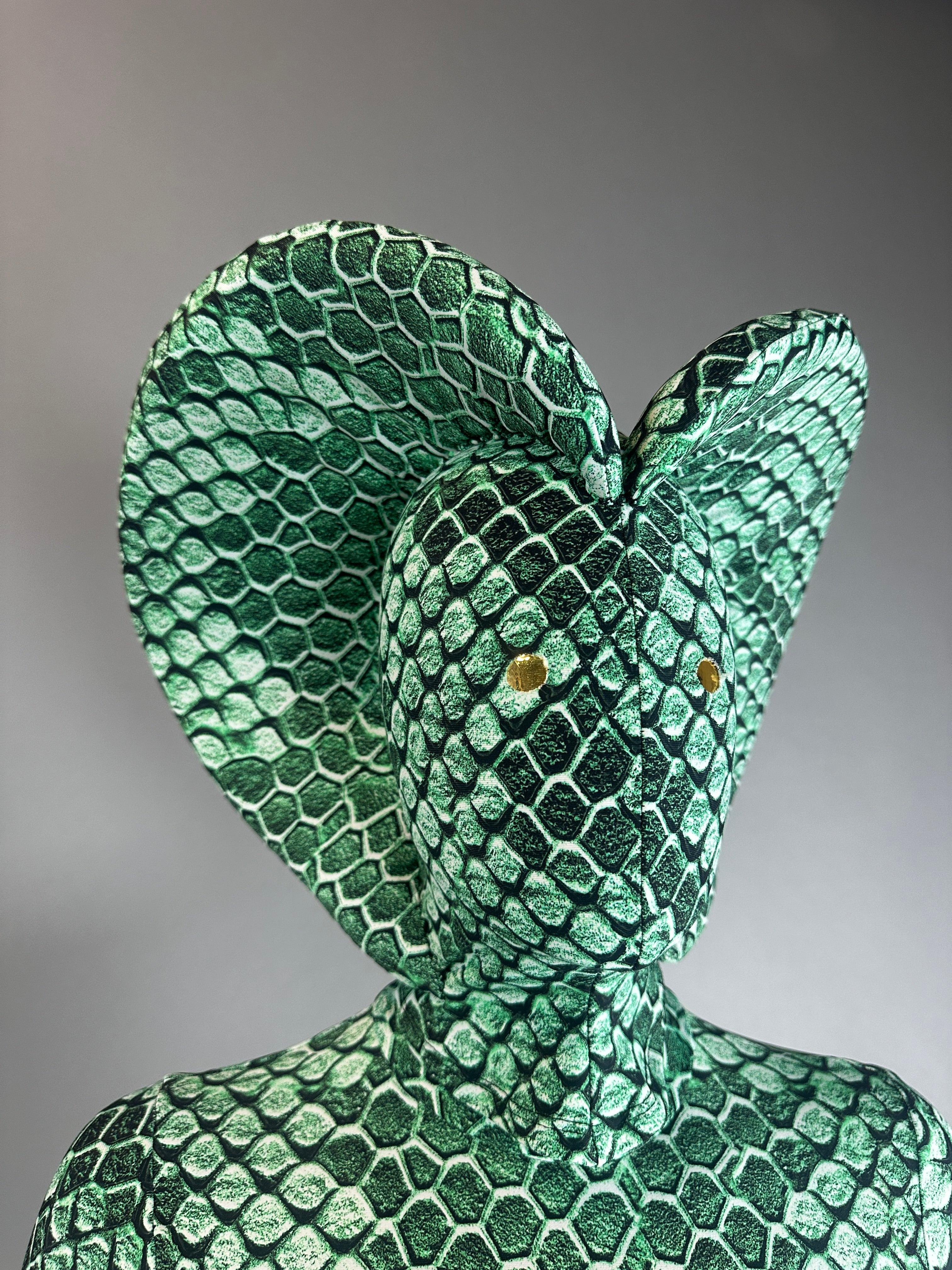 Model poses in the Green pixel Cobra Costume, a custom-made snake print catsuit with a striking headdress, perfect for serpent cosplay, contortionists, or dance performances—shown here against a gray backdrop.