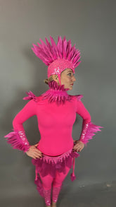 Person wearing the Pink Bird Headpiece, a fairy hat accessory with feathered accents, styled as aerialist headwear and theatrical costume prop, standing against a plain gray background.