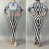 Model styled in the Glamorous sequins Stripes Catsuit costume featuring black and white stripes, sheer sleeves, blue ornate front designs, and sparkling sequined leaf accents.