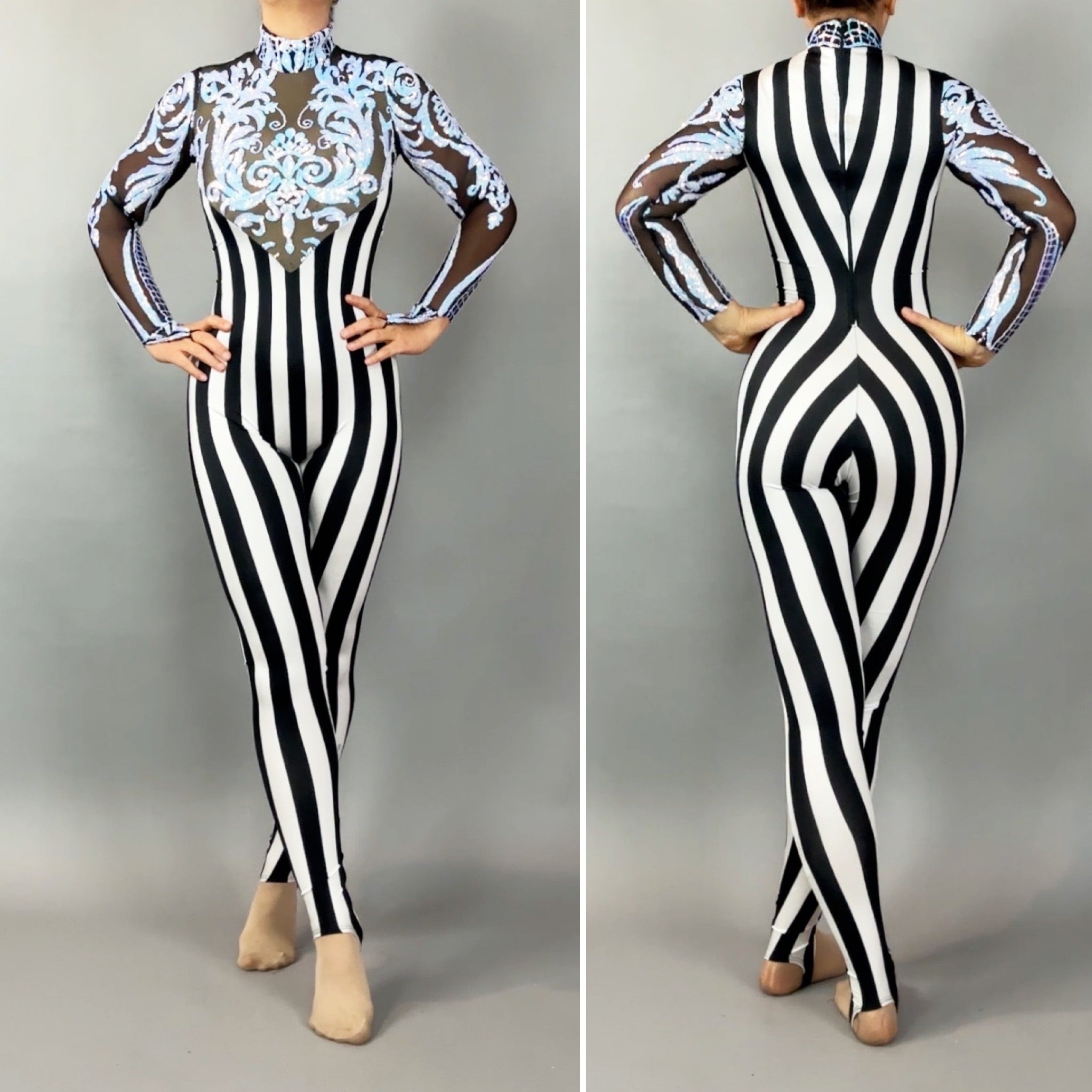 Model styled in the Glamorous sequins Stripes Catsuit costume featuring black and white stripes, sheer sleeves, blue ornate front designs, and sparkling sequined leaf accents.