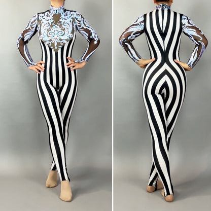 Model styled in the Glamorous sequins Stripes Catsuit costume featuring black and white stripes, sheer sleeves, blue ornate front designs, and sparkling sequined leaf accents.