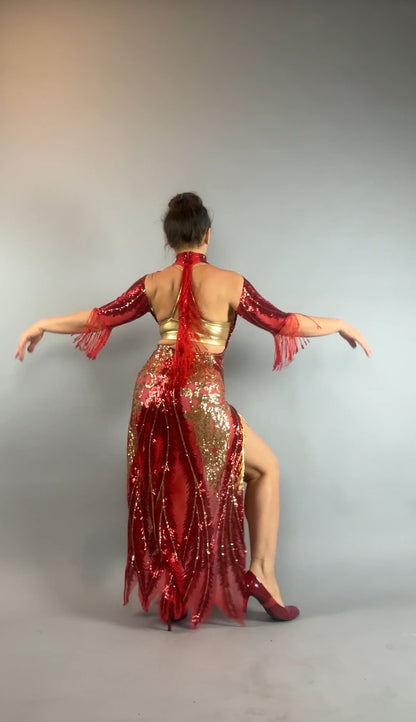 A woman poses with arms out, seen from the back against a gray background, wearing the bearded French accessories Sequin Sheer Dress—backless with beaded fringe accessories.