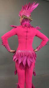 Person wearing the Pink bird full costume for aerial gymnastics, dancers, and TV productions, seen from the back with a bright pink feathered design and headpiece against a plain background.