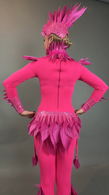 Person wearing the Pink bird full costume for aerial gymnastics, dancers, and TV productions, seen from the back with a bright pink feathered design and headpiece against a plain background.