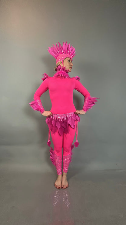 A person in the Pink Bird full costume for aerial gymnastics, dancers, and TV productions poses barefoot against a plain gray background.