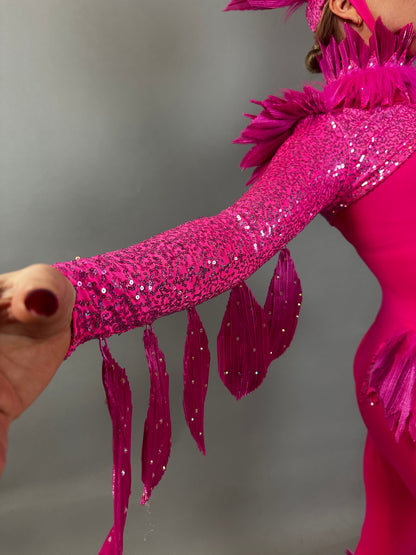 Wearing the Pink Bird Full Costume for aerialists and dancers—complete with sequins and fringe—this performer strikes a confident pose against a plain background, ready to shine on stage.