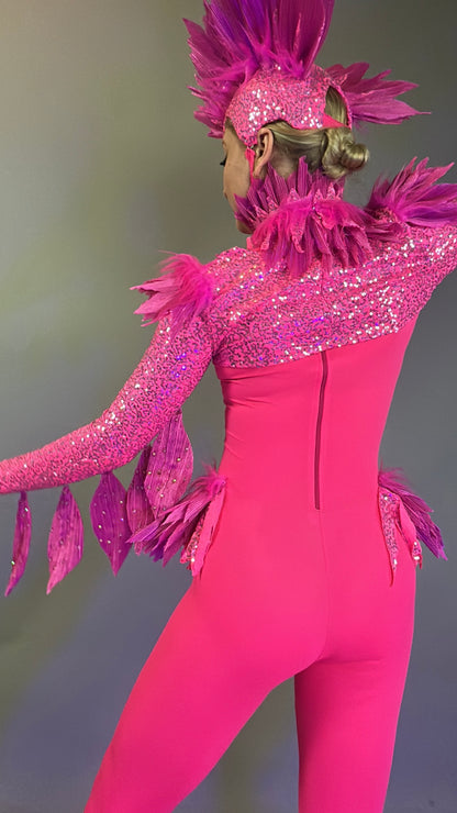 Person wearing the Pink bird full costume for aerial and dancers, featuring bright pink feathers and sparkly details, with headpiece, shown from the back against a plain background.