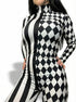 Woman poses with hands on hips in a Black and White Split Fabric Catsuit featuring full sleeves, turtleneck, bold stripe and diamond patterns.