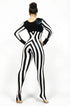 A person wearing a Black and White Striped Jumpsuit with a round neck and full sleeves stands with hands on hips, facing away.