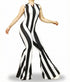 Someone models the Black and White Stripes Bell Bottom Catsuit with a front zipper and sleeveless design, featuring flared legs, while posing against a white background.