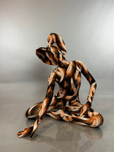 A person in a hooded Brown Snake Print Turtleneck Catsuit with Back Zipper sits on the floor.