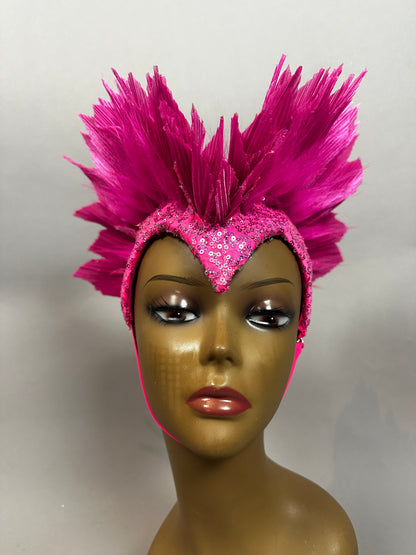 Mannequin head displays the Pink Bird Headpiece—a fairy hat and theatrical headwear for aerialists—featuring bright pink feathers and sequins in a dramatic fan shape, reminiscent of butterfly wings.