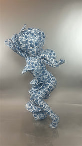 A figure clad in the Mushroom Creature Costume, an avant-garde full body suit featuring a marble print and custom fit, stands against a gray background.