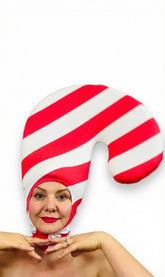 Person wearing the Candy Cane Headpiece—red and white stripe spandex hat, open face, lightweight stretch fabric—a festive holiday costume accessory that adds a whimsical touch.