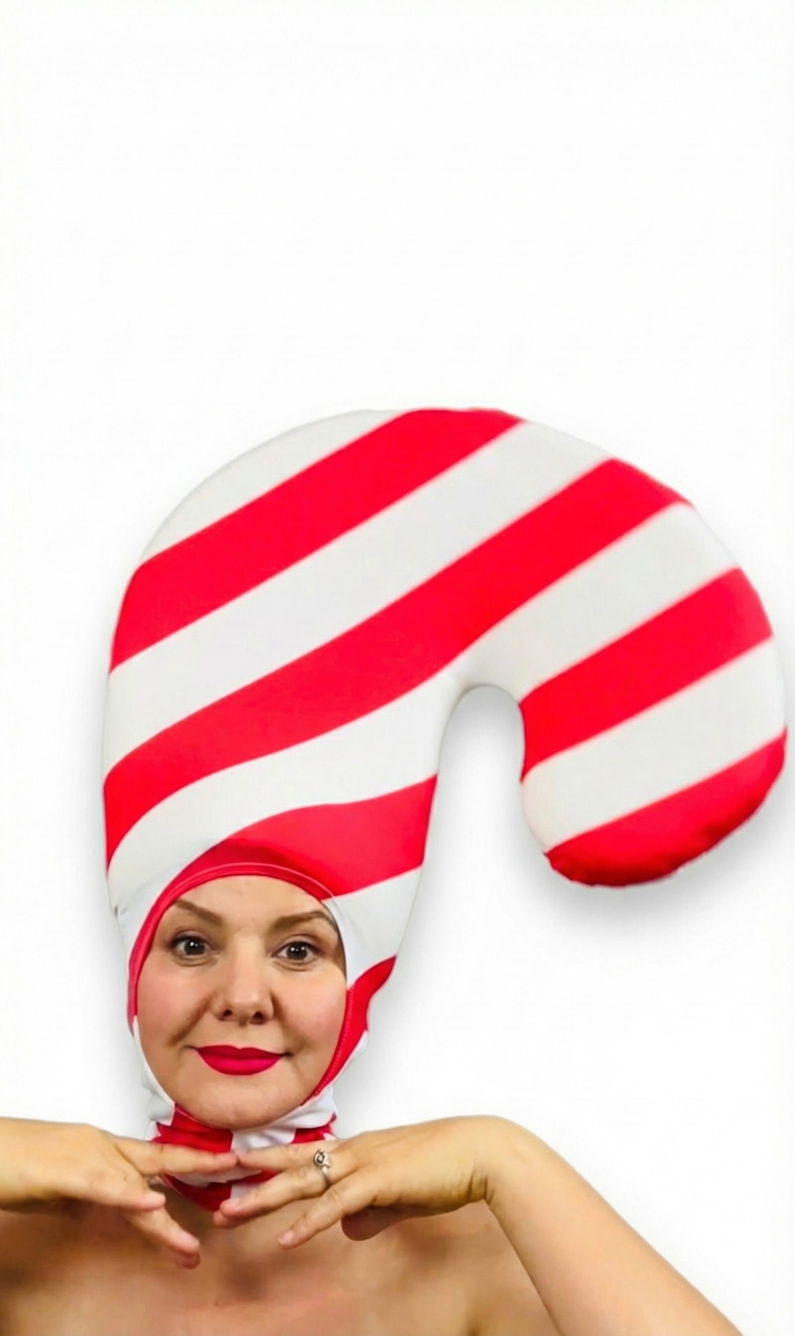 Person wearing the Candy Cane Headpiece—red and white stripe spandex hat, open face, lightweight stretch fabric—a festive holiday costume accessory that adds a whimsical touch.