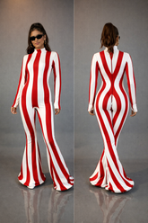 Woman in the Rave White Striped Catsuit with bellbottom legs, featuring bold white stripes, shown from front and back with sunglasses—a standout performance jumpsuit.