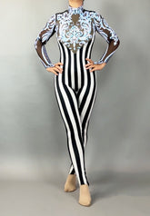 Wearing the Glamorous sequins Stripes Catsuit costume, this person sports black-and-white stripes, sheer sleeves, ornate blue chest detailing, and a sparkling sequined leaf accent.