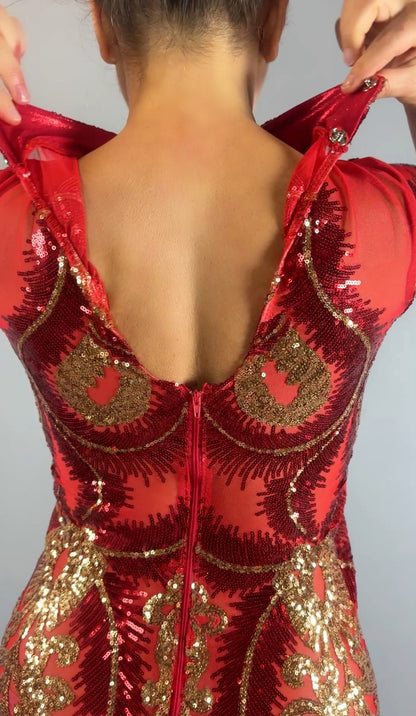 Person zipping up the Red And Gold Sequin Sheer Dress, a sleeveless maxi style with gold accents, shown from the back while wearing hand accessories.