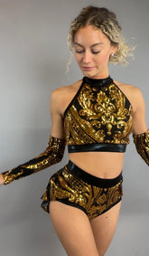 A woman poses against a plain gray background wearing the Gold Sequin on Black Crop Top and Bottom Set, featuring a halterneck top with hand accessories.