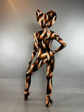A person wearing a Brown Cobra Costume with a snake-print catsuit and a wide, cobra-shaped headpiece.