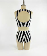 A mannequin wears the Exotic Dance Costume—black and white striped crop top with high-waisted bikini bottoms—shown from the back, perfect as a trending festival outfit.