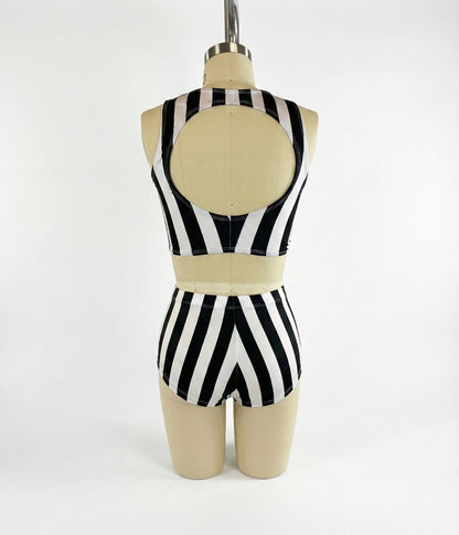 A mannequin wears the Exotic Dance Costume—black and white striped crop top with high-waisted bikini bottoms—shown from the back, perfect as a trending festival outfit.