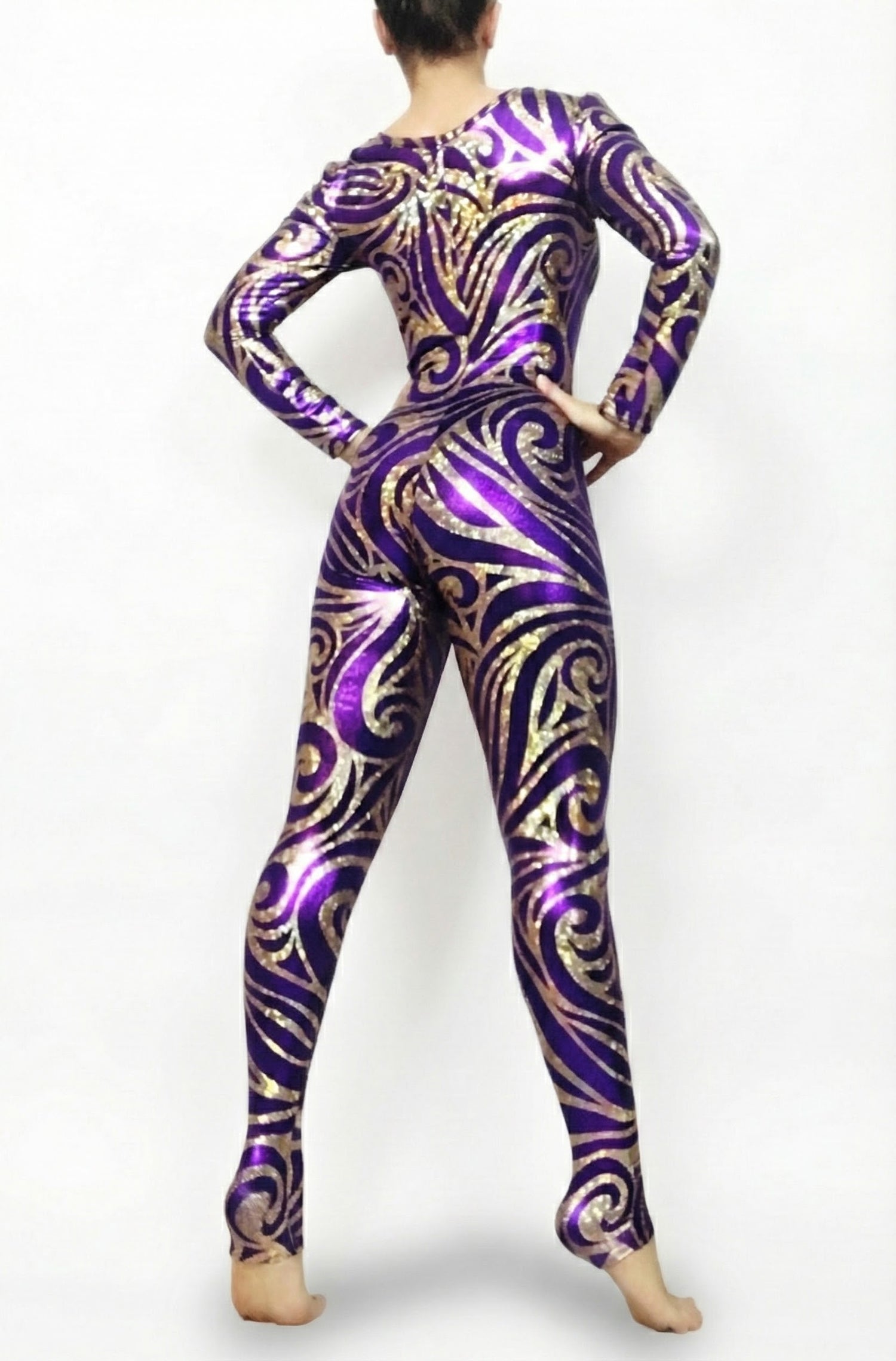 A person in a creative cosplay wears the Frozen Snowflake Purple Gold Catsuit with a round neck and full sleeves, standing barefoot, hands on hips, back facing the camera.