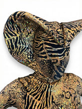 Person wearing the Gold Cobra Snake Costume—an abstract, shiny spandex catsuit custom-made for gymnastics, acrobatics, dancers, or contortionists—with large pointed ears and no visible face, shown against a white background.