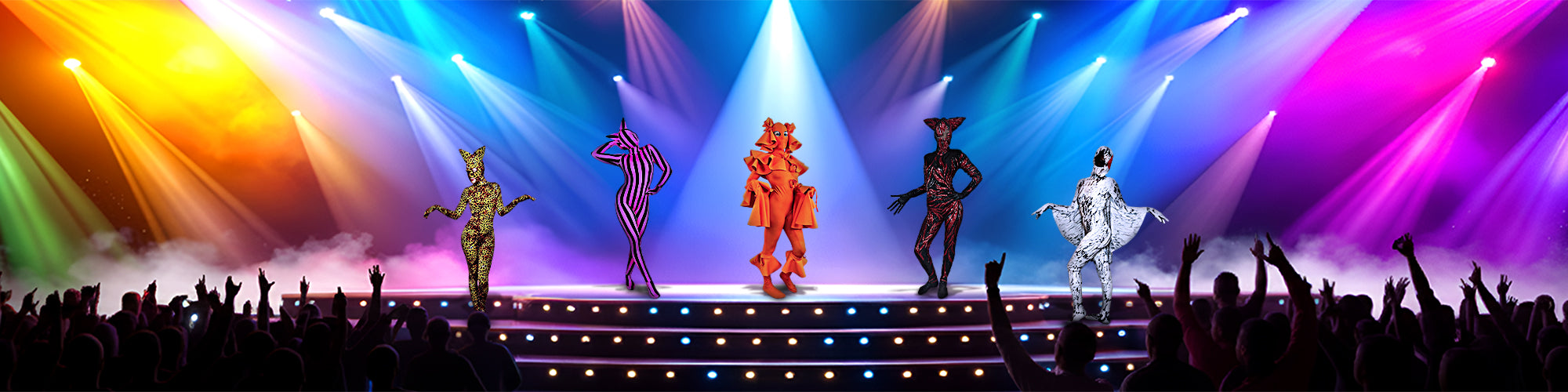 Five masked performers in elaborate costumes stand on a lit stage with colorful spotlights and cheering crowd.
