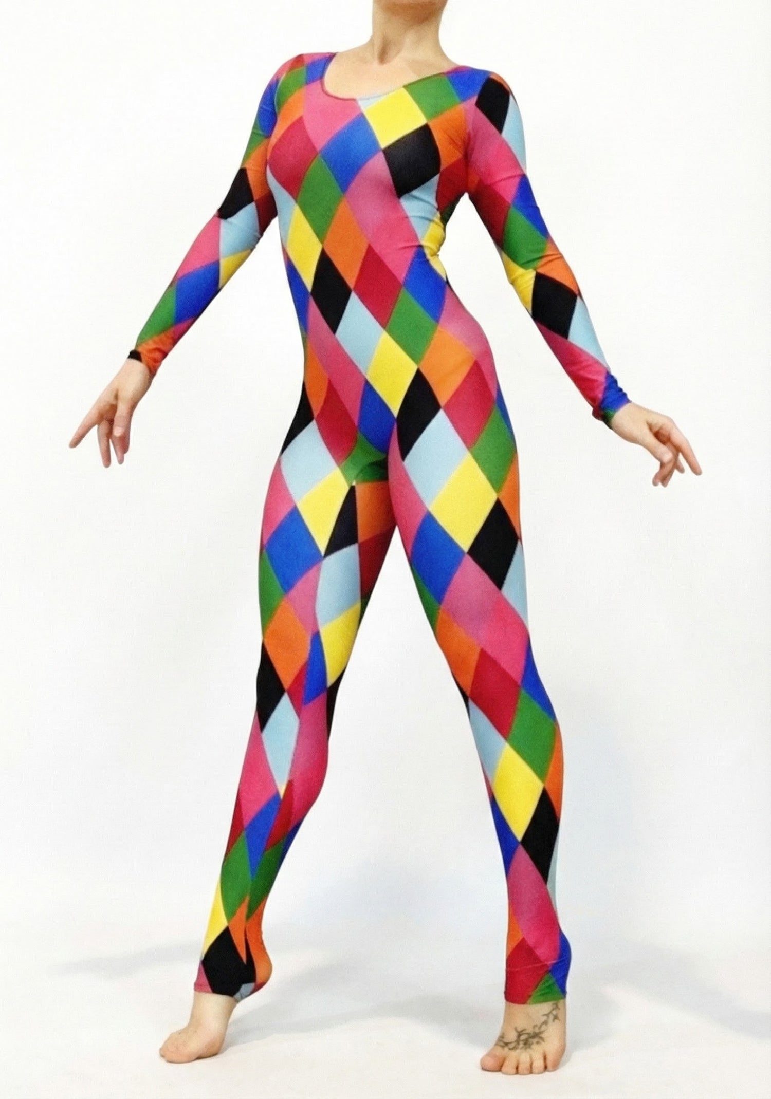 Model wears a Multicolor Catsuit Harlequin Costume featuring full sleeves and a scoop neck with diamond patterns, posed against a plain white background.