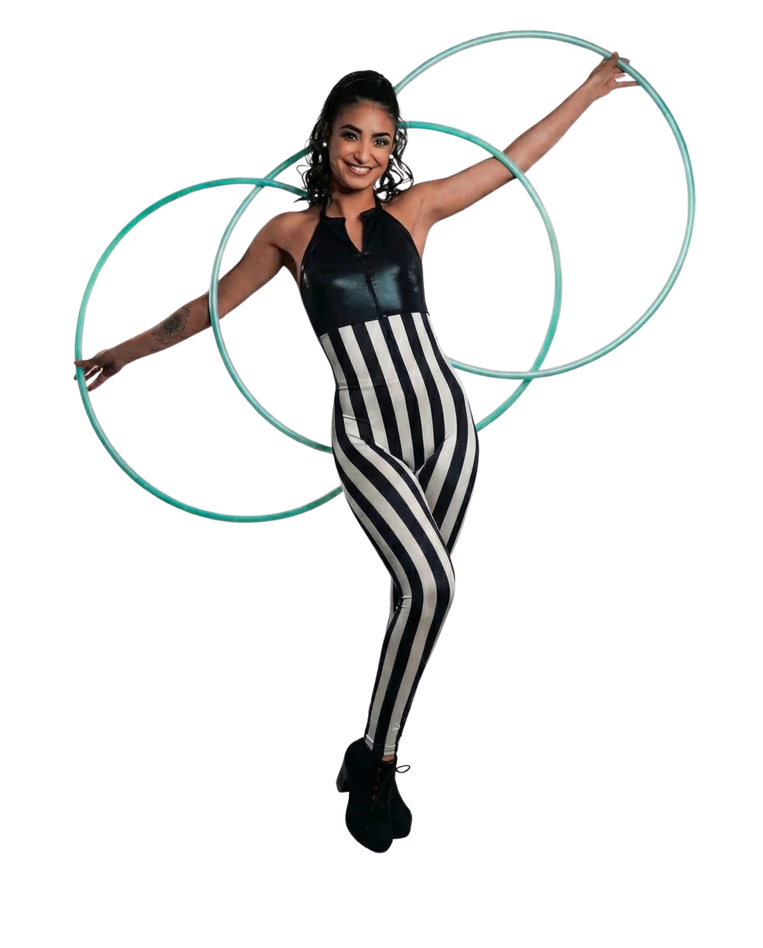 Woman in a black and white striped spandex catsuit with hologram halter top poses with three hula hoops against a white background. The full body stretch suit features a front zipper, perfect for performance wear.