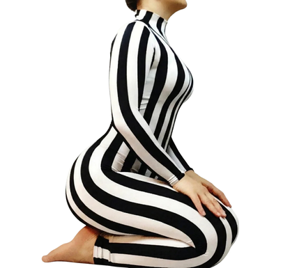 A person kneels against a white background, wearing the Black and White Striped Catsuit with full sleeves and turtleneck.