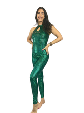 Woman smiles confidently in the Beautiful Bodysuit—a shiny green metallic print catsuit perfect for gymnasts, exotic dancewear, and trending now. She stands barefoot against a white background, radiating performer energy.