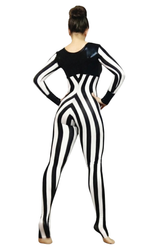 A woman stands barefoot with her hair in a bun, wearing the Black and White Striped Jumpsuit with a round neck and full sleeves.