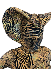 Model wearing the Gold Cobra, a custom-made gold and black snake costume with animal print spandex, a sculpted pointed hood resembling a snake headdress, and no visible face—ideal for gymnasts, dancers, and acrobats.