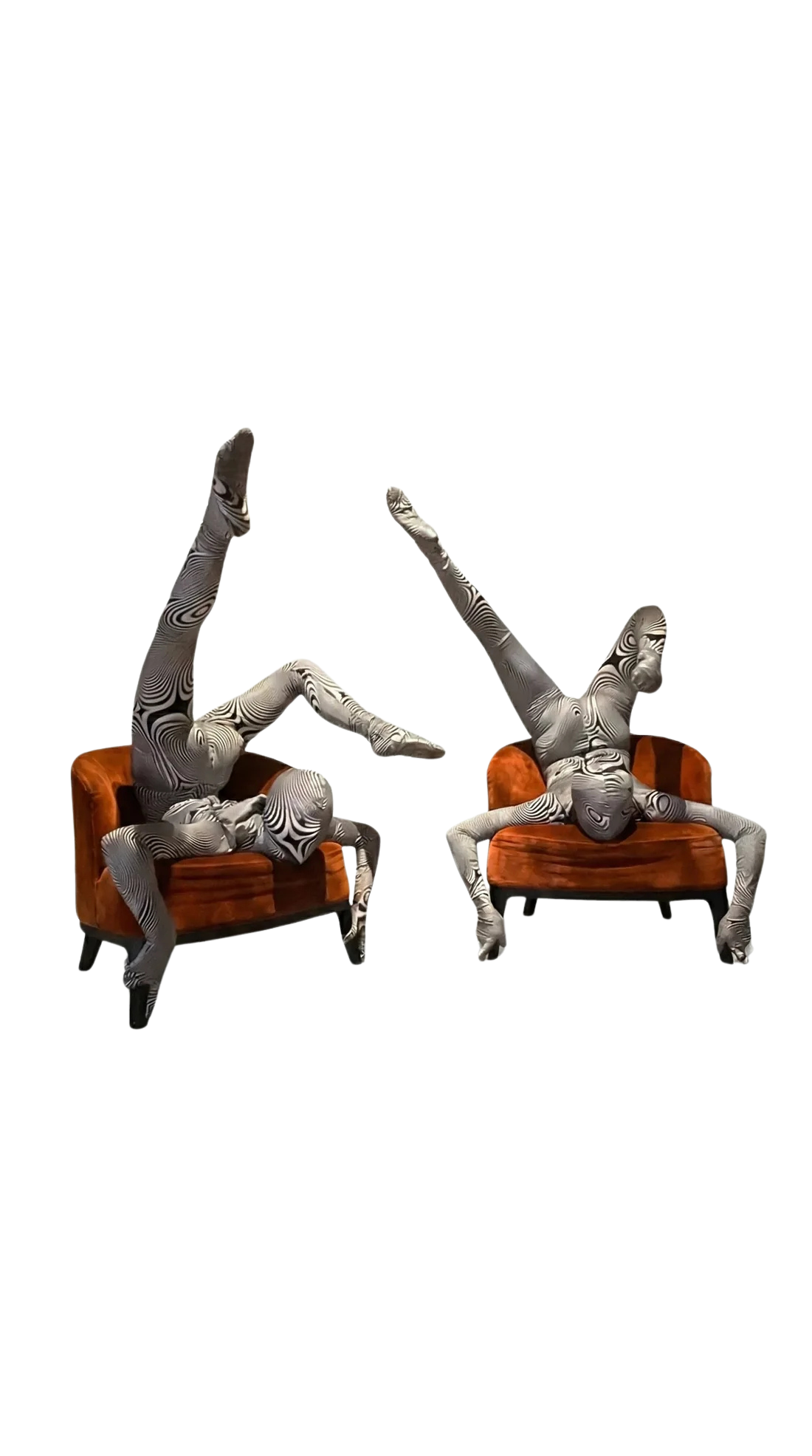Two performers in Alien Costumes pose on orange chairs, balancing with legs extended upward. Their futuristic, artistic outfits highlight their flexibility and turn them into living works of art perfect for festivals or exotic dance wear.