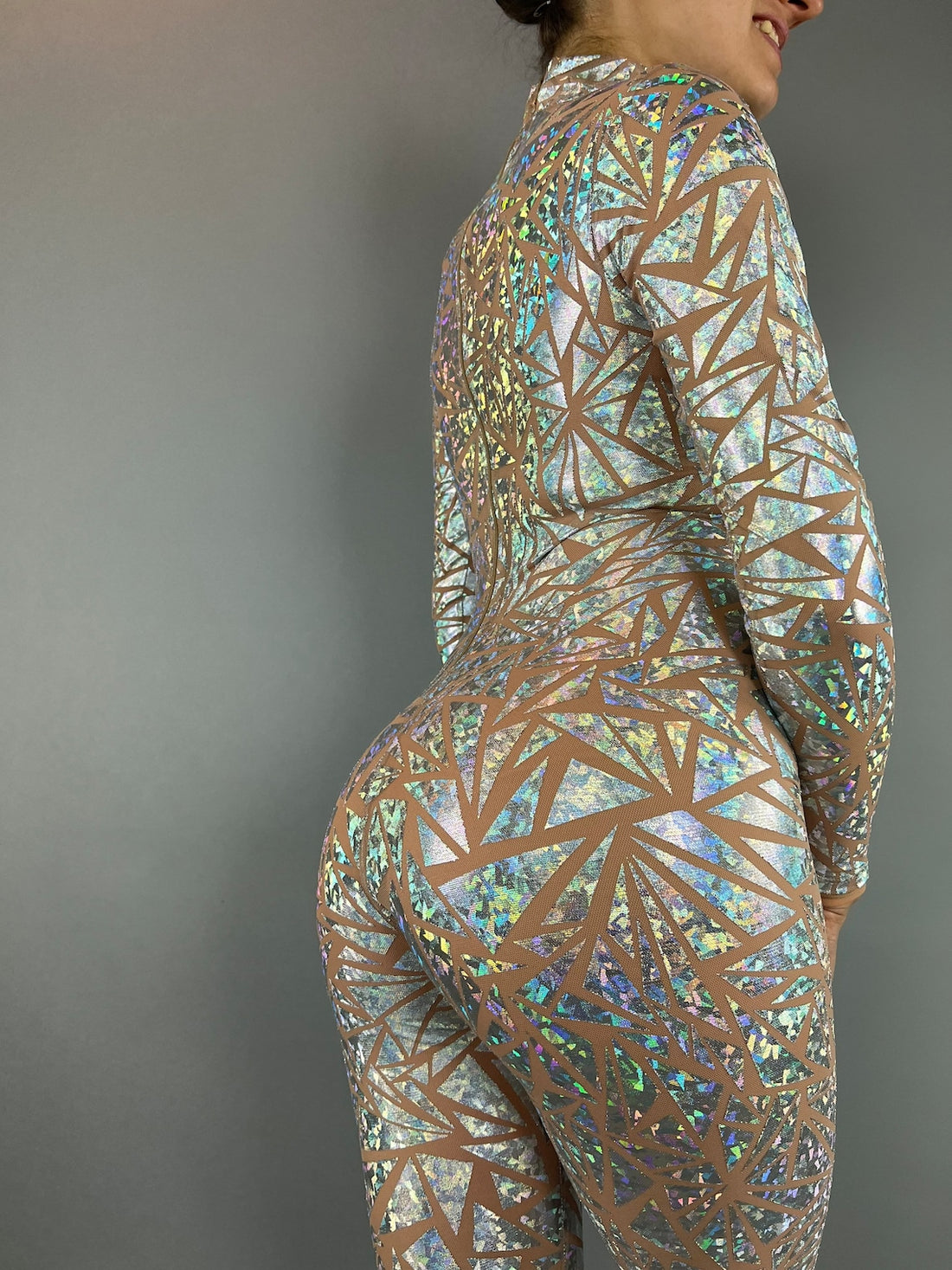 A person in the Shiny Showgirl Costume, an eye-catching geometric-patterned bodysuit, strikes a pose against a plain background.