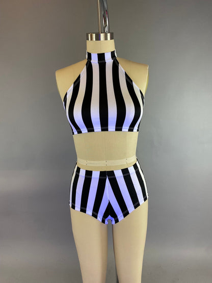 A mannequin wears the Exotic Dance Costume, featuring a black and white striped halter crop top and matching high-waisted bikini bottoms.