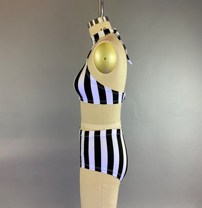 Mannequin wearing the Exotic Dance Costume, a black and white striped bikini set with high-waisted bottoms from the Trending Now collection, against a plain background.