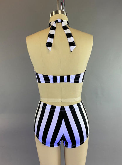 Back view of a mannequin showcasing the Exotic Dance Costume, featuring a black and white striped halter bikini set with high-waisted bottoms, perfect for pole dancing.