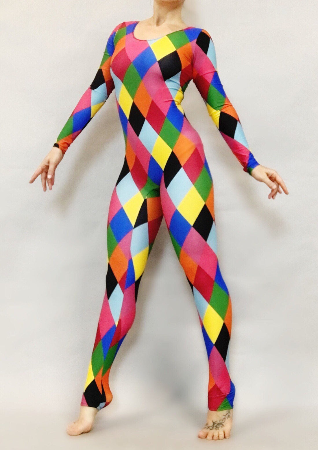 Someone posing in the Multicolor Catsuit, a harlequin costume featuring full sleeves and a scoop neck, set against a plain background.