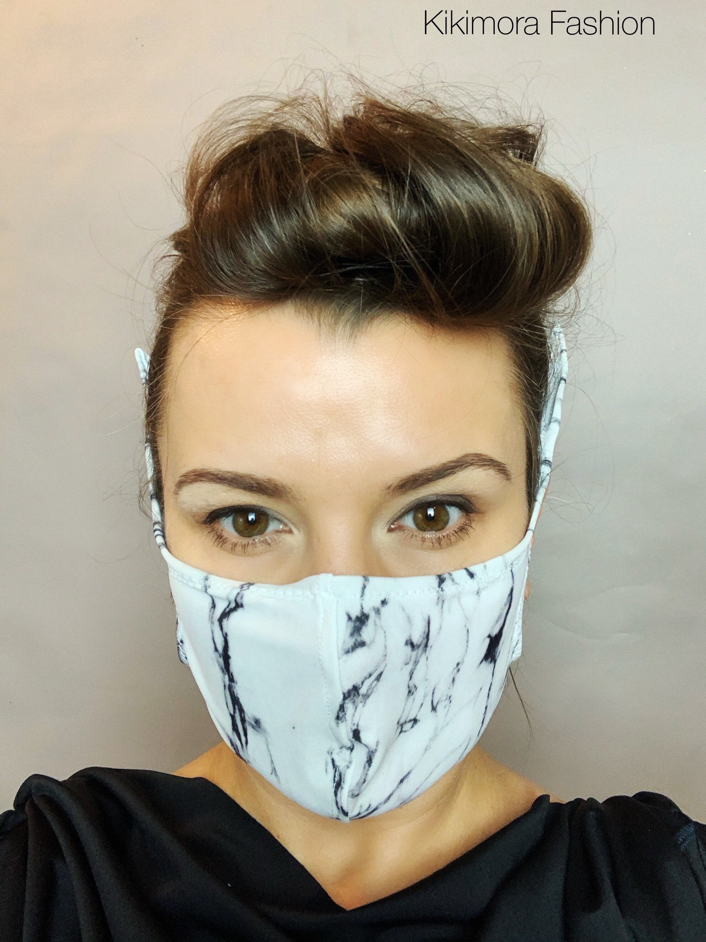 Woman wearing the Face Mask, Elf Ears Cosplay Costume Accessory made from Lycra with a white and black marble pattern and "Kikimora Fashion" in the corner. This Breathing Face Mask is perfect for cosplay events.