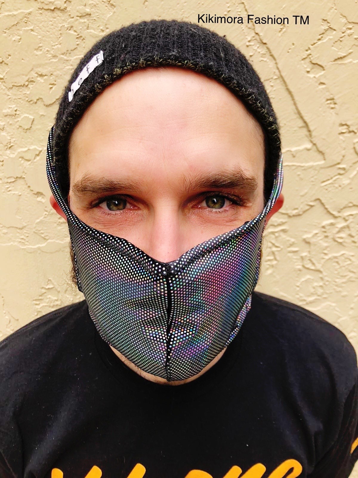 A person in a knit beanie and an Elf Ears Face Mask for All Ages from Kikimora Fashion looks directly at the camera.