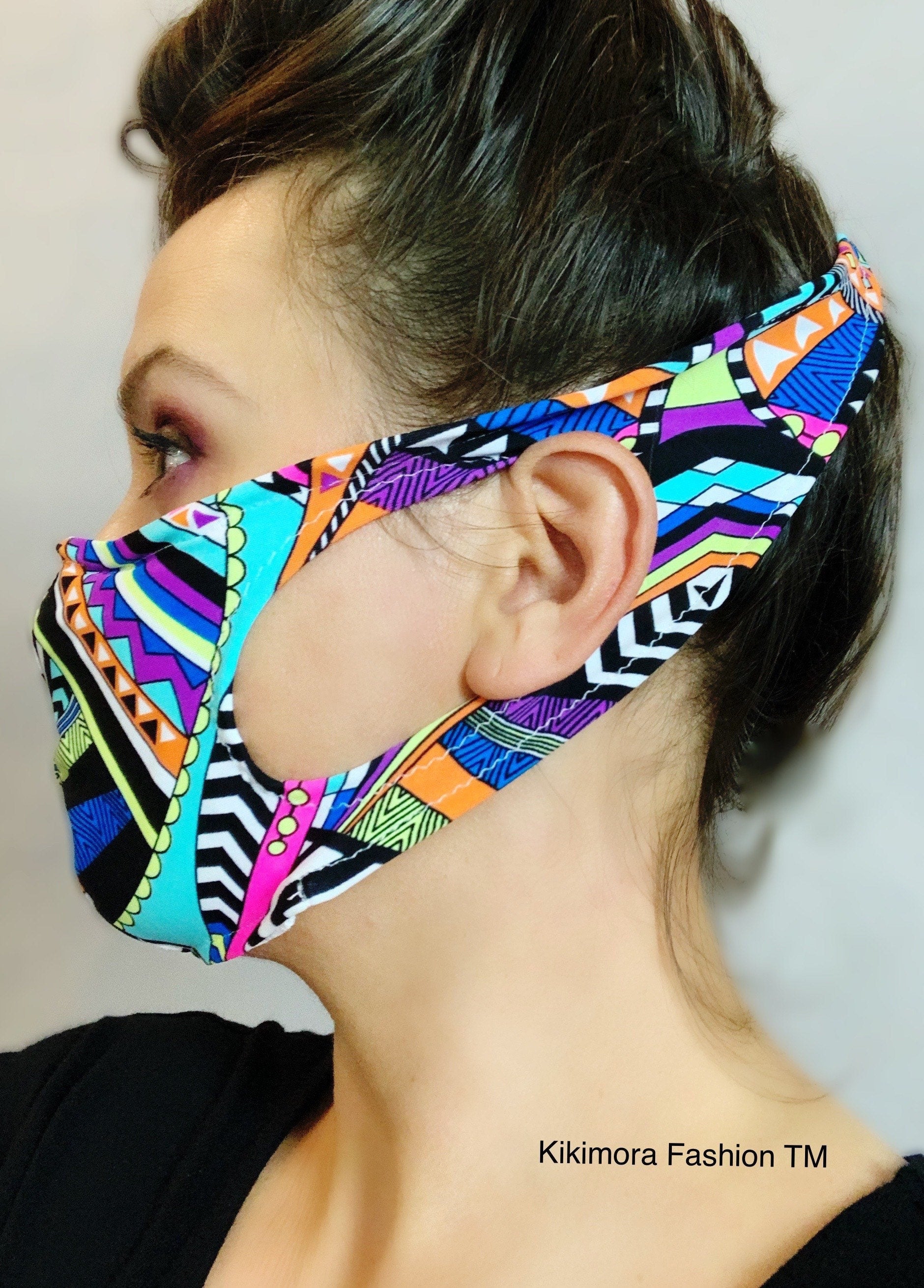Woman wearing a colorful Glow Face Mask With 5 Layer HEPA Filter, Fashion Accessory, featuring head straps and embracing sustainable fashion.